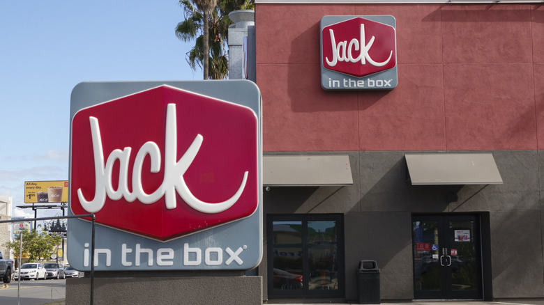 A Jack in the Box logo is displayed on a sign outside of a restaurant
