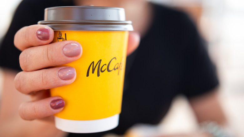 Close up of hand holding McDonald's coffee