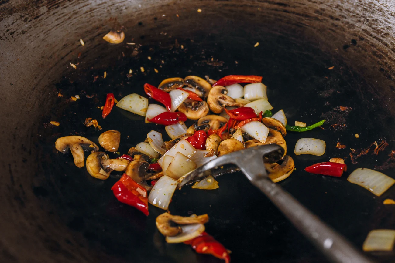 stir-frying onions, mushrooms and peppers