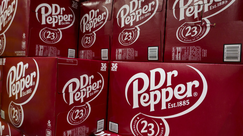 Cases of Dr Pepper are displayed on store shelf.