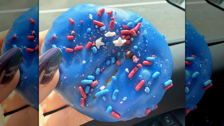 Hand holding Rocket Pop Donut from Dunkin'