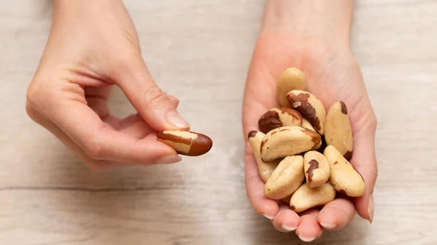 Woman's hand holding brazil nuts