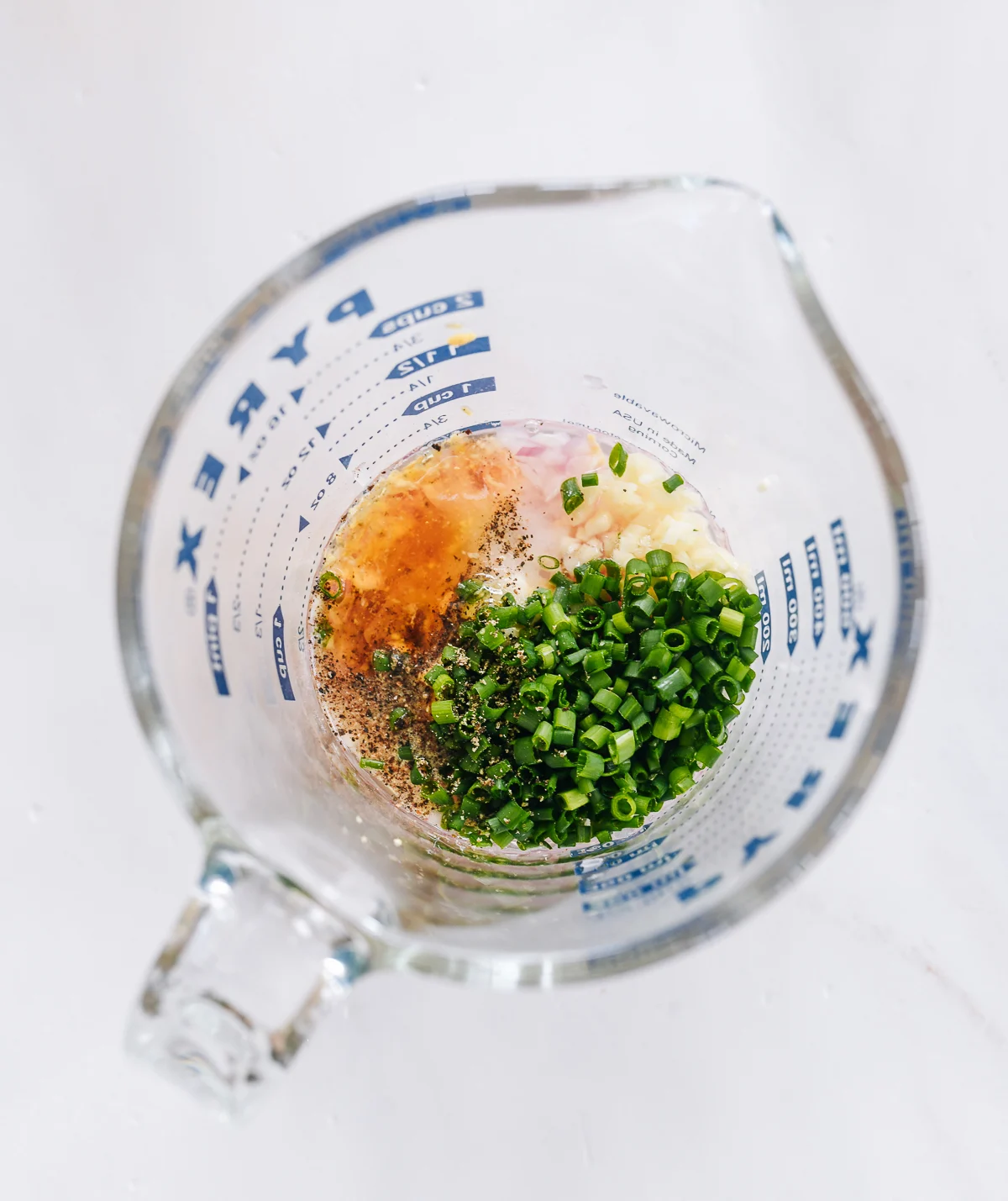 shallot vinaigrette ingredients in measuring cup