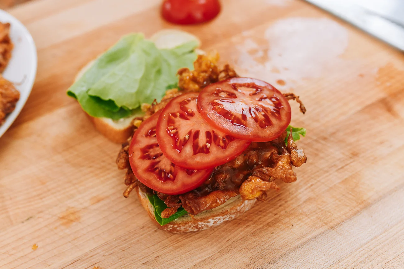 tomato slices on egg foo young sandwich