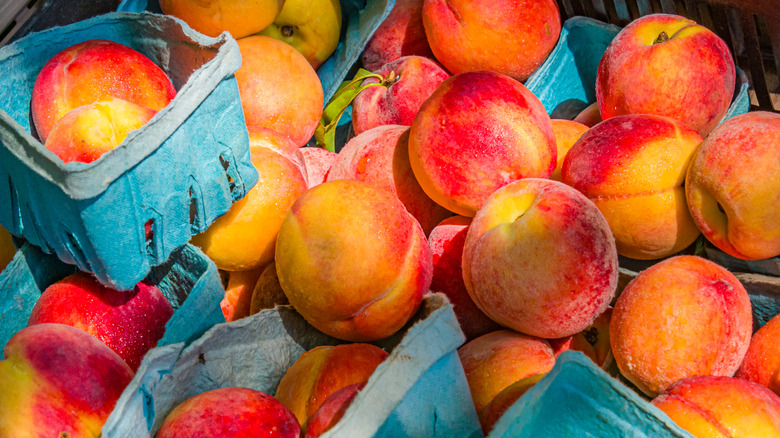 Boxes of fresh peaches stacked together