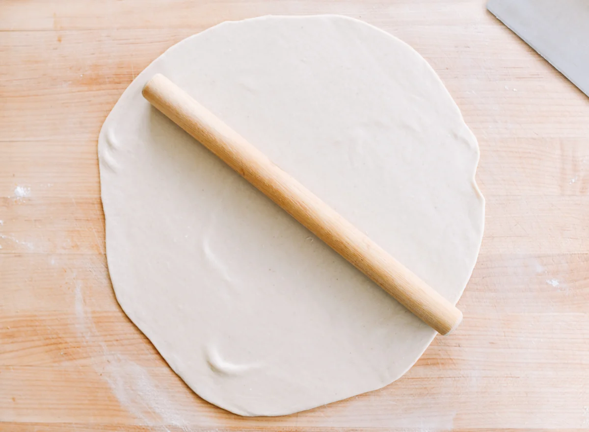 dough rolled out into thin, large circle