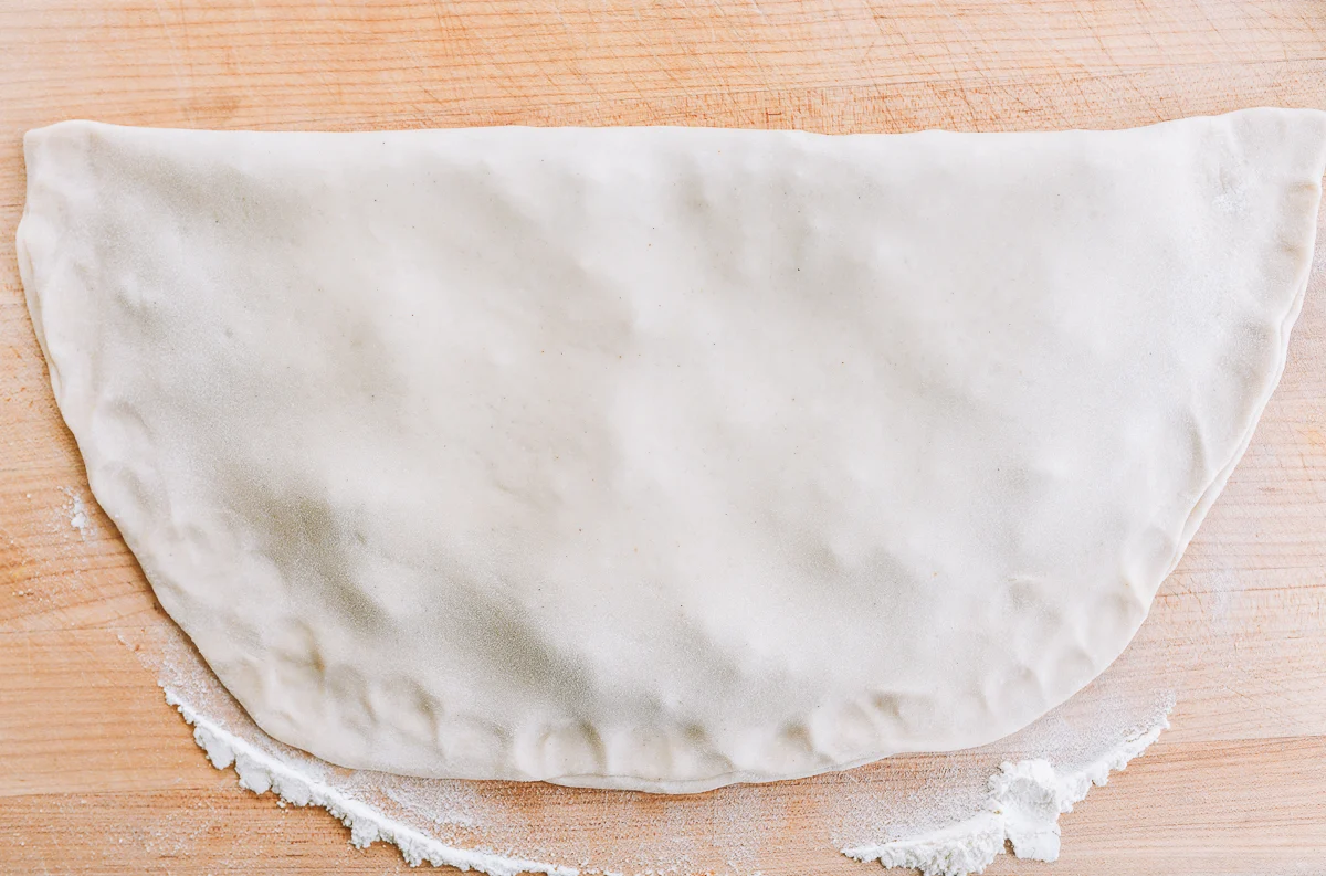 thin dough folded in half with filling