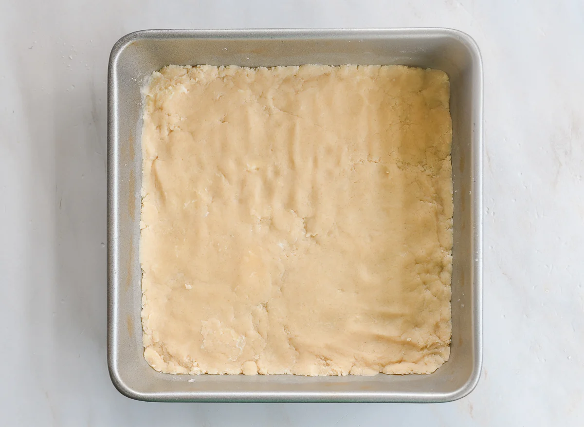 dough pressed into 9x9 inch square pan for crust