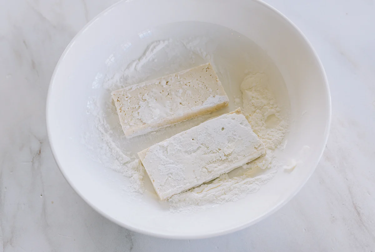 coating tofu slices in cornstarch