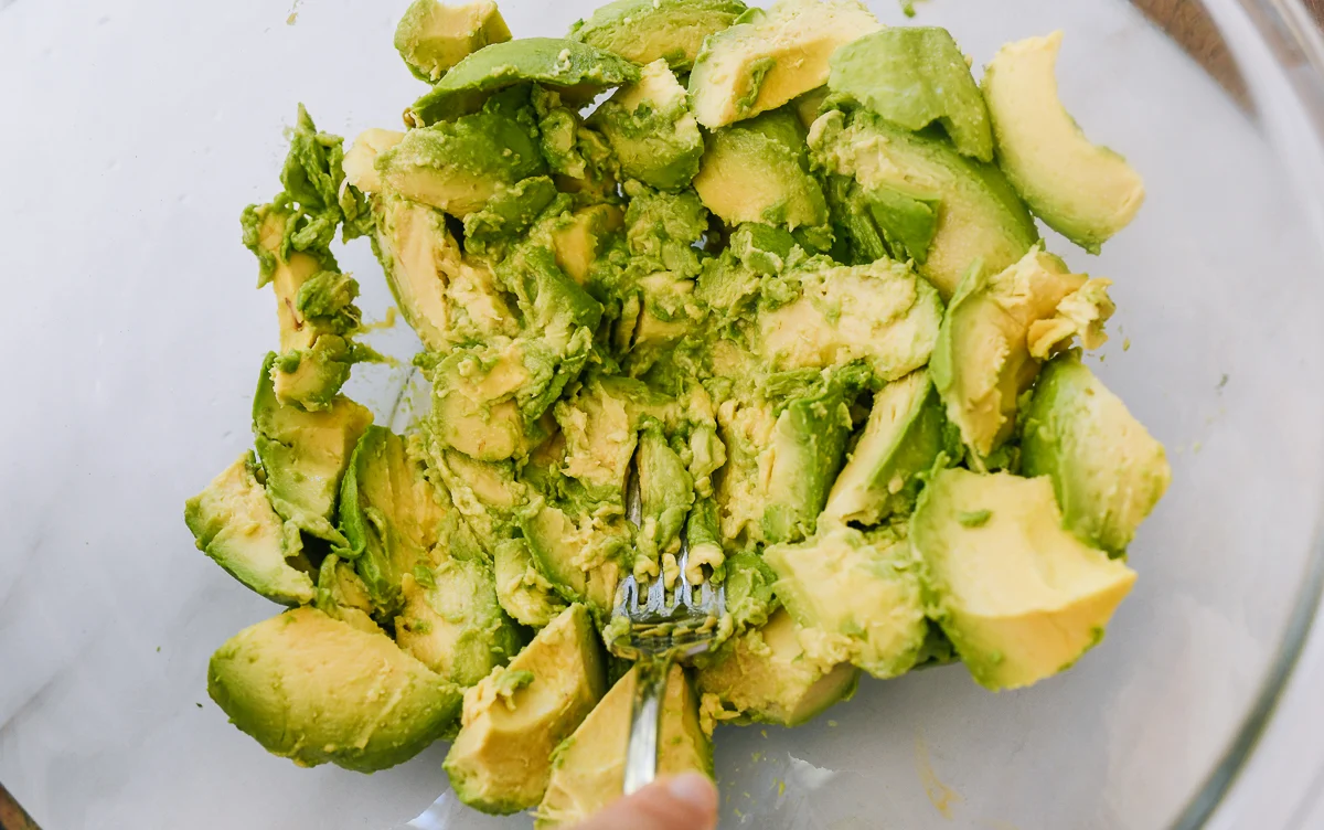 mashing avocado with fork