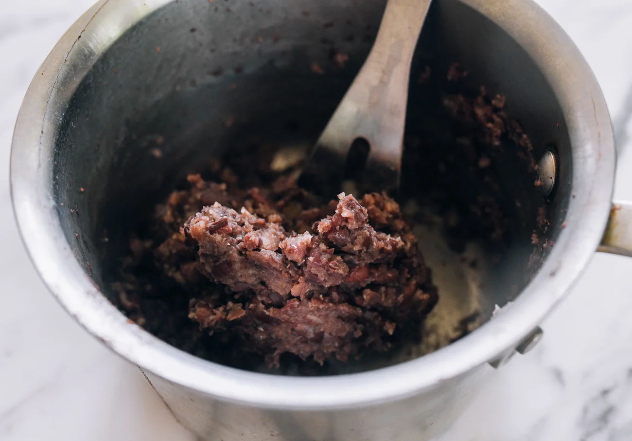 mashed cooked red beans in pot