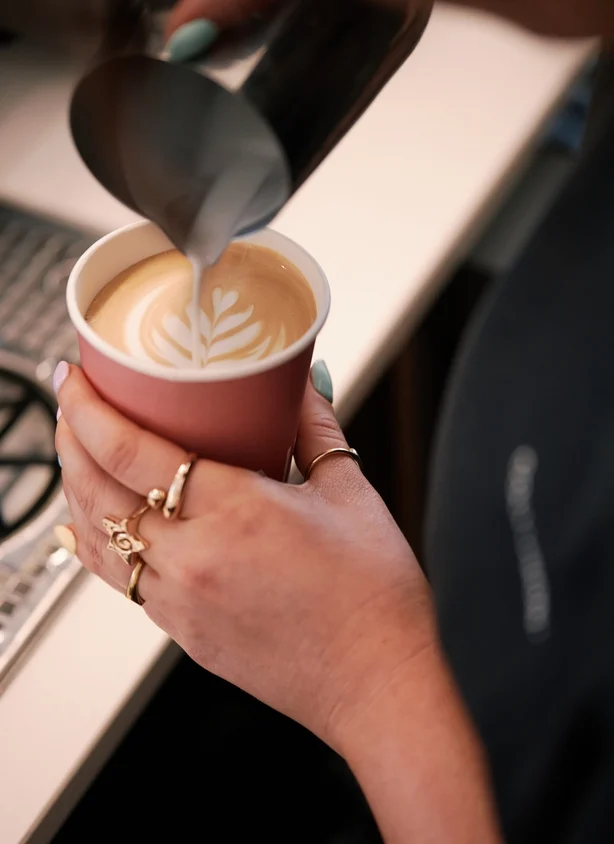 A barista making a coffee