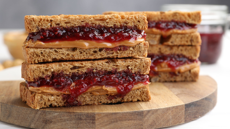 Slices of peanut butter and jelly sandwiches stacked on top of each other.