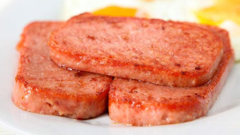Three fried slices of Spam meat.