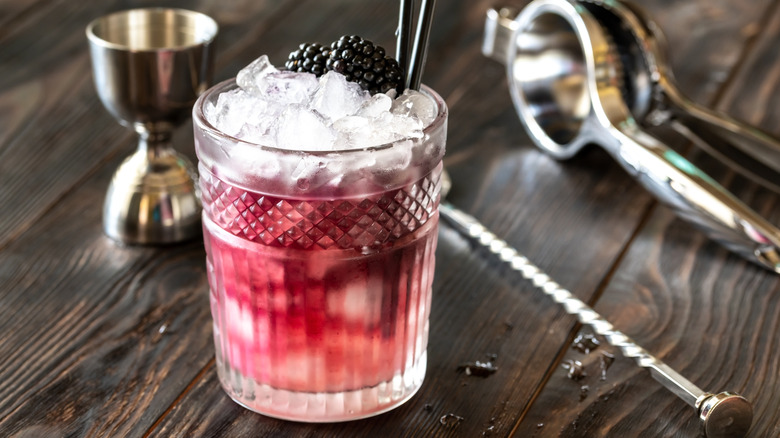 Glass of Bramble cocktail made of gin, lemon juice, sugar sypup and creme de mure