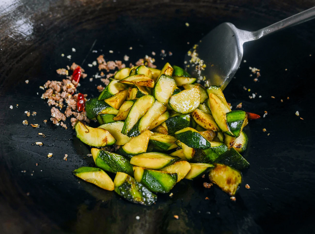 seared zucchini added to ground pork mixture