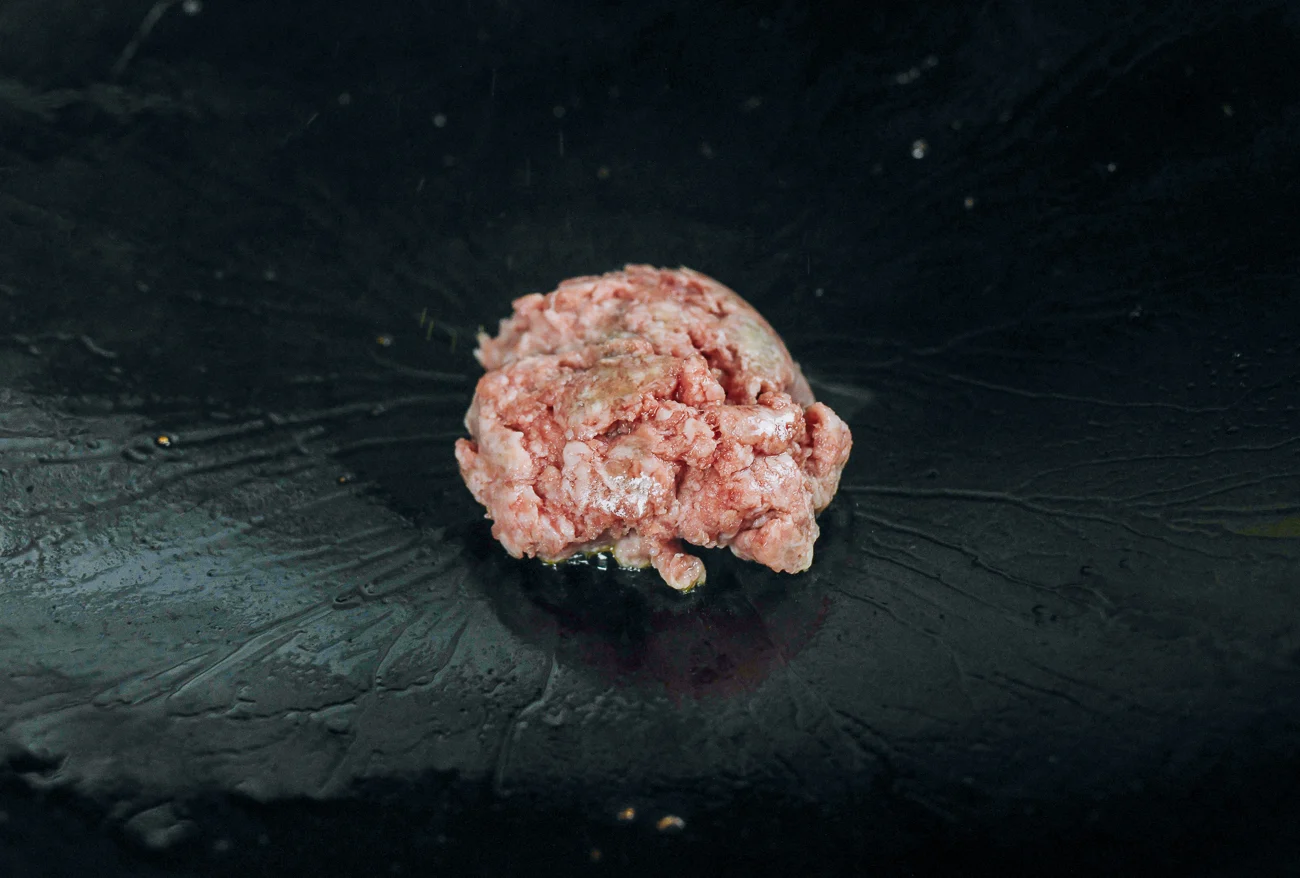 ground pork added to wok