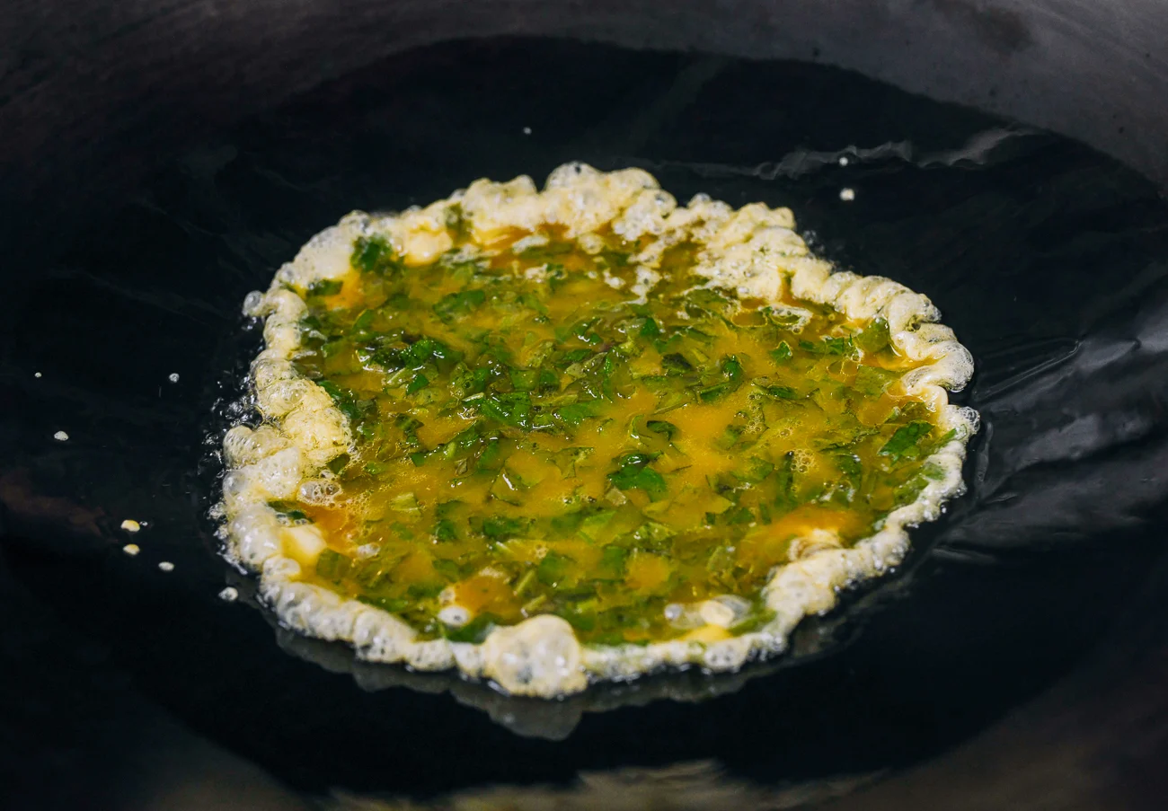 egg and shiso mixture added to oil in wok