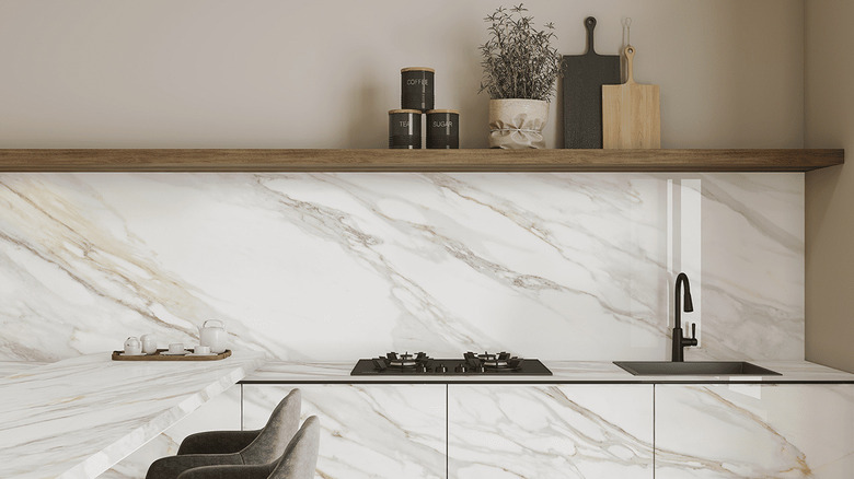 Stunning marble style porcelain worktop from Porceko used for backsplash, cupboard doors, and breakfast bar in a show kitchen