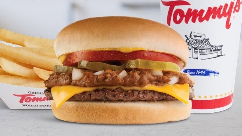 Original Tommy's chili cheeseburger flanked by a side of fries and a fountain drink.