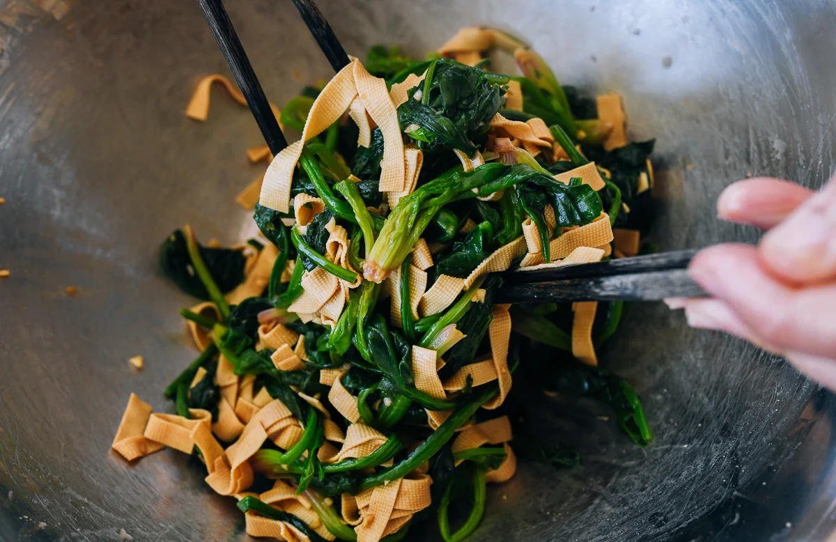 tossing Chinese spinach salad together