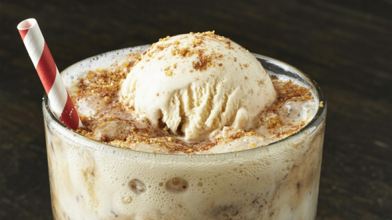 root beer float in a glass with striped straw