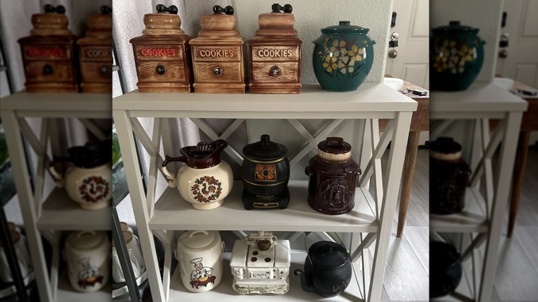 Various McCoy cookie jars on a white shelf.