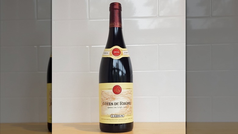 bottle of wine against white wall