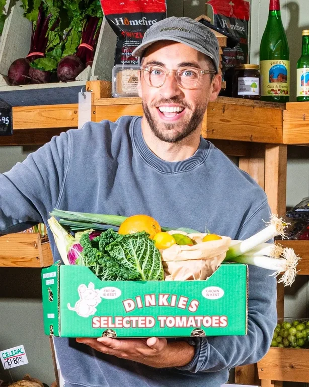 Makin holding a box of veg