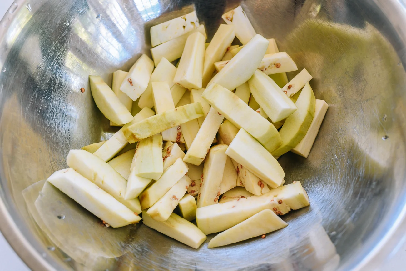 eggplant sticks in metal mixing bowl