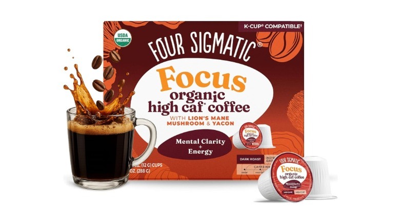 A box of Four Sigmatic Focus High Caf Coffee in a box, a pod, and made in a clear coffee mug, on a white background