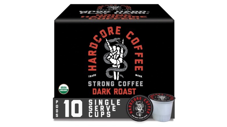 A box of Hardcore Coffee Dark Roast single-serve cups, with a couple of pods out in front, on a white background