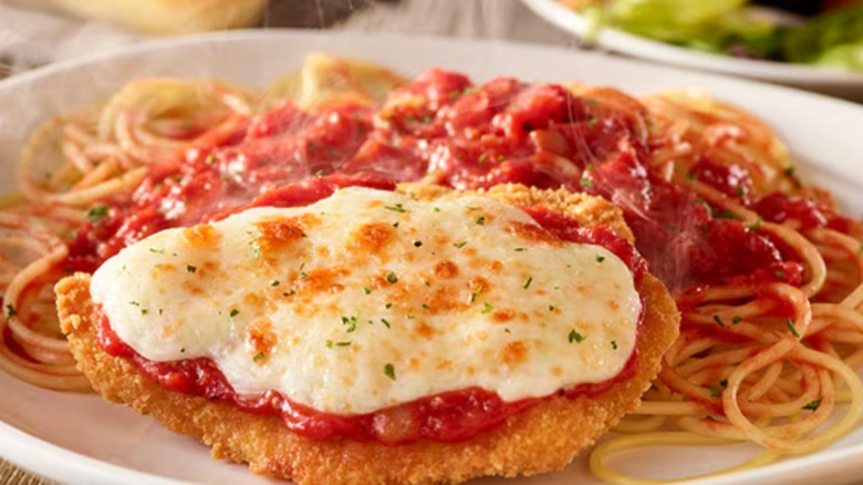 Chicken Parmigiana with cheese on top served at Olive Garden