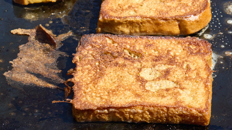 Closeup view of cooking French toast on griddle