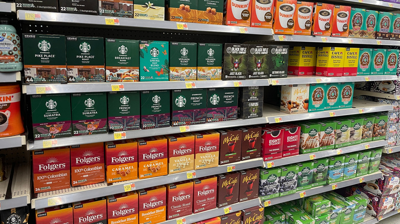 Supermarket shelves with a variety of boxed coffee pods
