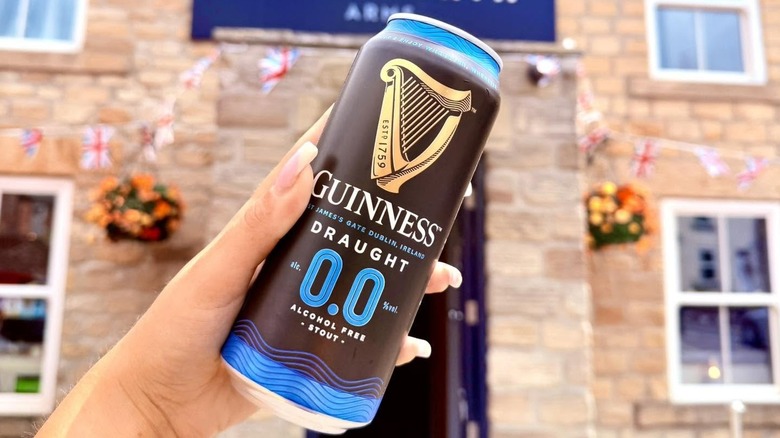 Woman holding a Guinness 0.0 can