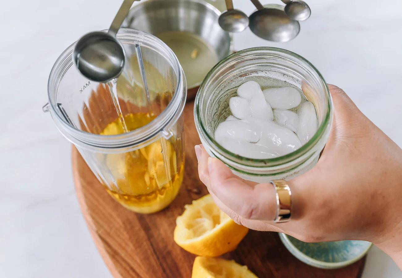 adding ice water to blender with oil