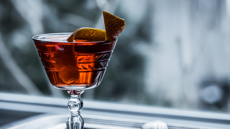 A Bamboo cocktail served in a vintage glass with a twist.