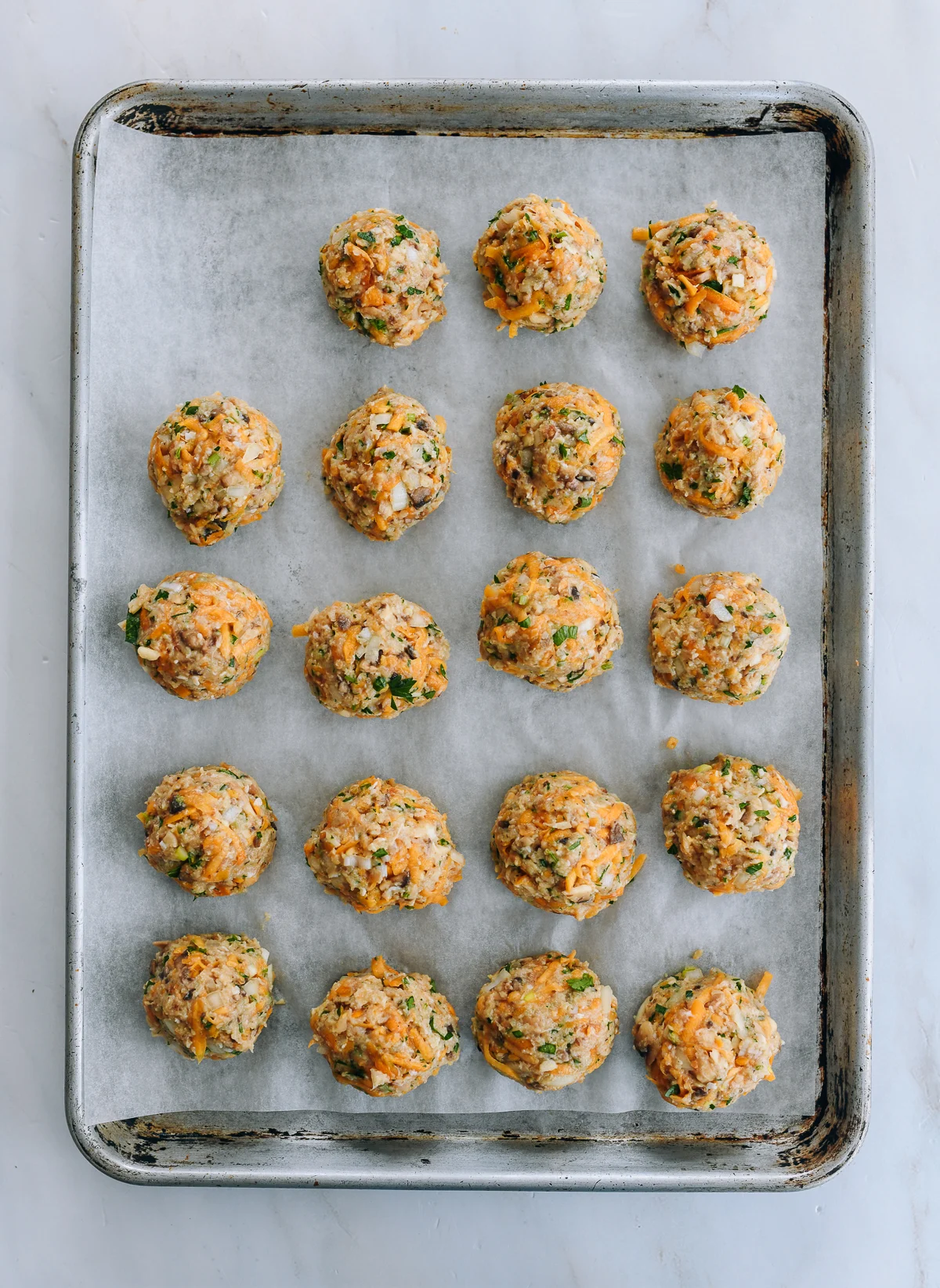chicken meatballs on baking sheet before baking