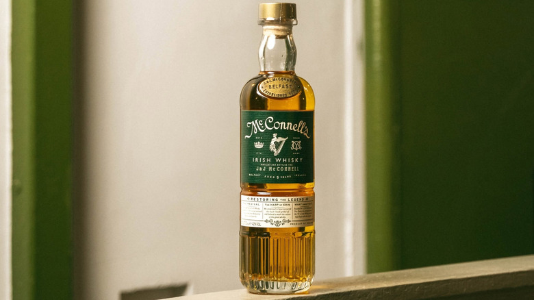 A bottle of McConnell's 5-year perched on top of a railing