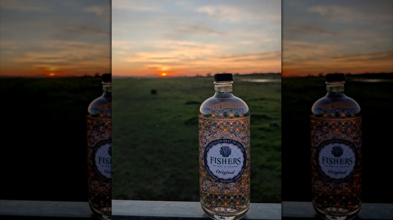 bottle of fishers gin on fence