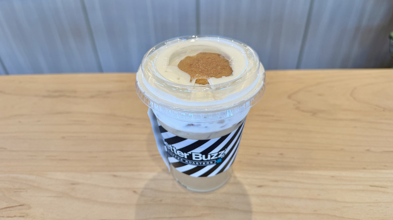 An iced banana bread latte on a wooden table