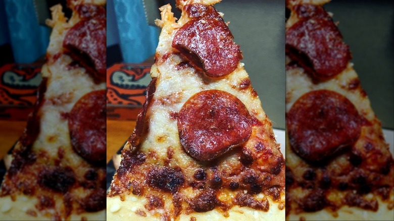 Slice of greasy pepperoni pizza from Little Caesars