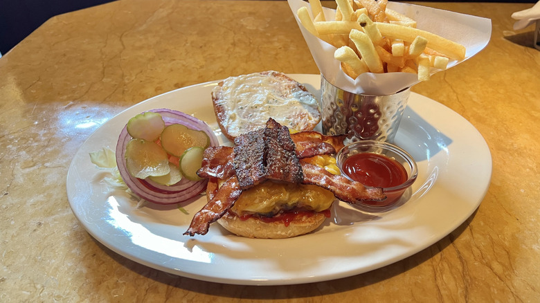 Cheesecake Factory Bacon-Bacon Cheeseburger and fries on plate.