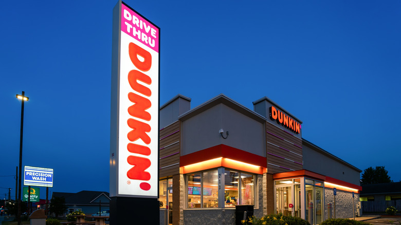 Dunkin' sign and restaurant at night