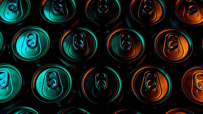 Beer can tops in shady green and black lighting