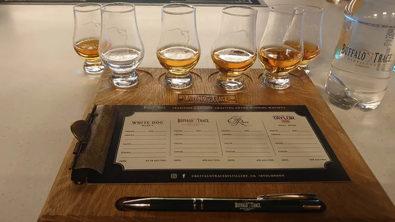 A whiskey tasting set up at Buffalo Trace showcasing a tasting mat with a section for each whiskey