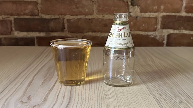 Close-up of a bottle of Miller High Life poured into a glass