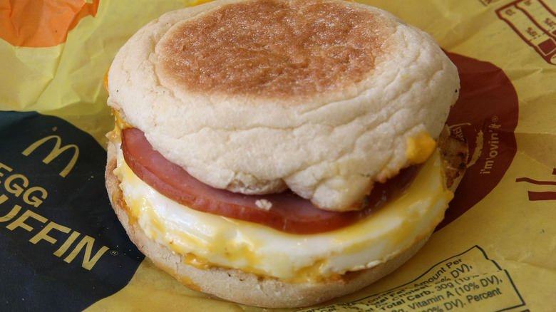 McDonald's McMuffin sitting on a yellow packaging paper.