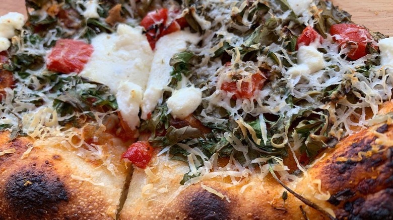Close-up of a vegetable pizza with a blistered crust